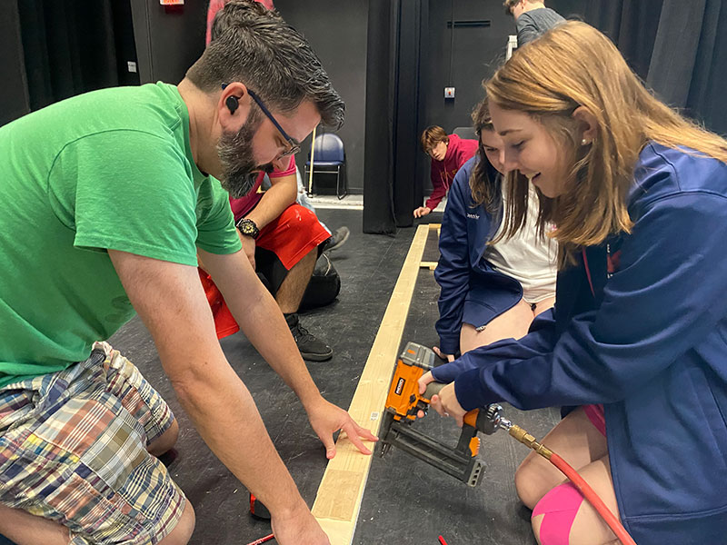 Although power tools scare her a little bit, its important that every one pitches in to build the set. I am using a staple gun to staple wood to other wood on the proscenium, sophomore Jolie Hartley said. Its my first time doing it, so its pretty fun! I like it. 