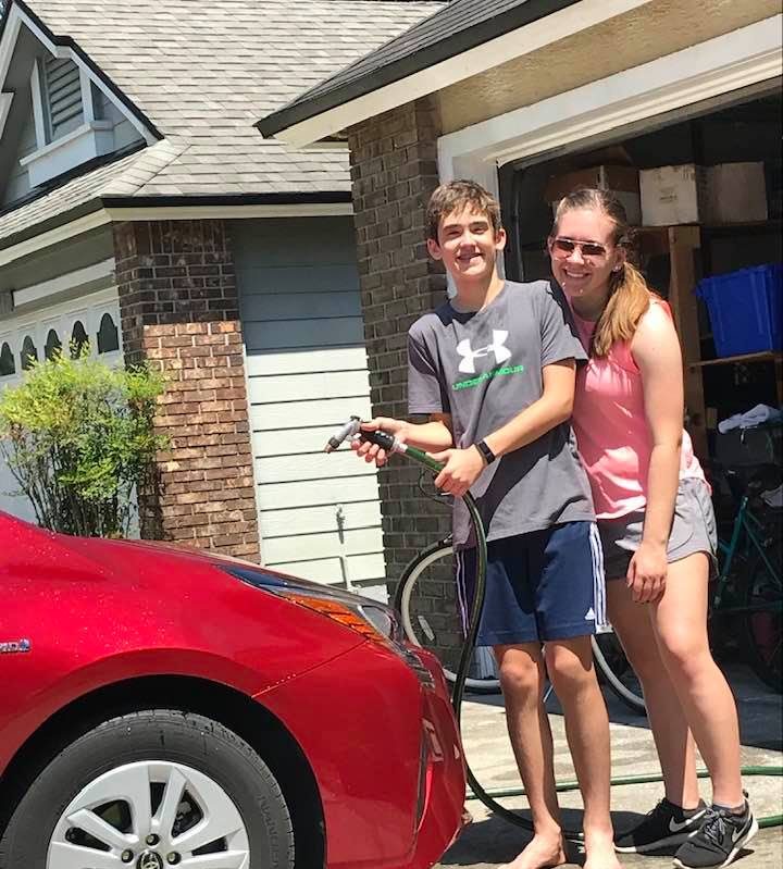 Senior Cassie Muse washes one of her familys cars with her little brother. Getting household chores out of the way is a great way to make use of time during quarantine.