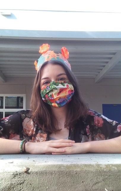 Junior Melissa Sargent poses with her favorite hand-made tropical mask. I really like this paradise mask I have, it is very colorful and goes with a lot of my clothes.