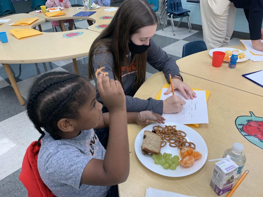 After the children are seated at their appropriate spots for lunch, the high school student-teachers go around to each of their assigned preschoolers to fill out a form regarding their day “We have a Sunshine Report where we have to ask them about their day and what they have been doing,” sophomore student-teacher Mayson Cooney said. “We also fill out a lunch form where we record what they are eating and how much of it. It’s important for their parents, so that their parents know what they did during the day, how much of their lunch that they ate, and what they need to pack or not pack in the future.”