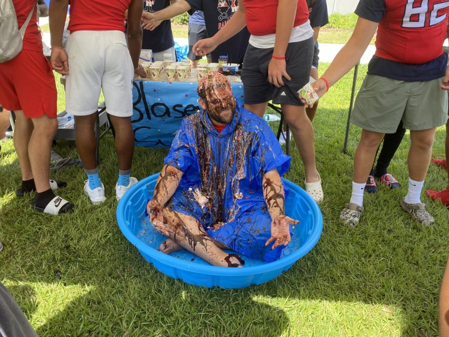 Principal Brian Blasewitz subjects himself to an ice cream bath during the Rivalry Week lunch pepe rally on Sept. 10.Our victory over Lake Mary is going to be sweet tonight, Blasewitz said.