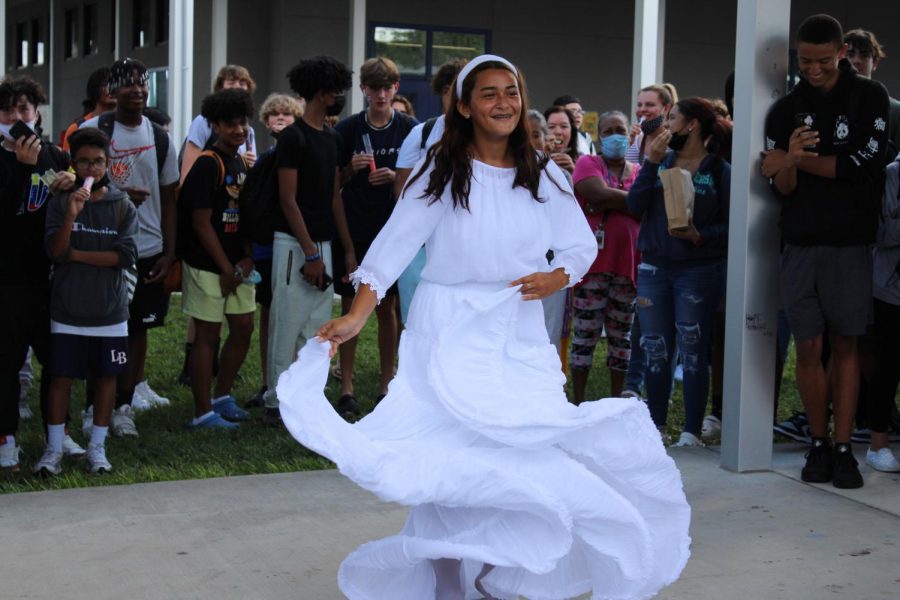 Junior Yulianys Rodriguez dances to ‘La Majestad Negra’ and students surround her to watch at the festival on Friday. “I felt really proud of myself; dancing and representing Puerto Rican culture and heritage made me feel proud of where I come from,” Rodriguez said.