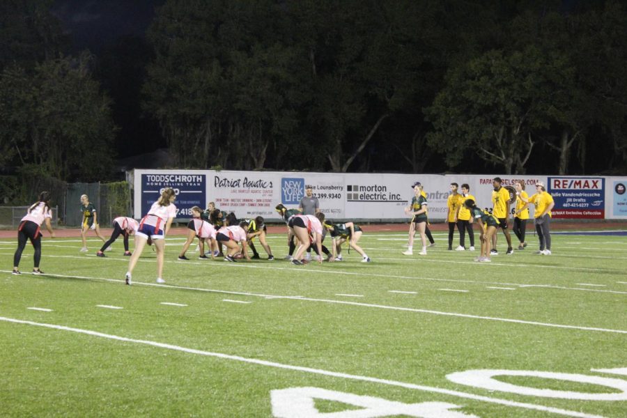 Senior Queens and Junior Jokers set up for one of the first plays of the Powderpuff game on Nov. 3. The first and only points of the game were scored by senior Maddie Jones 12 minutes and 46 seconds into the first half.