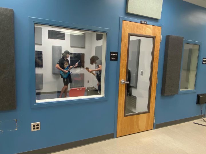 Students recording and practicing in one of the sound proof rooms that the audio club uses. 