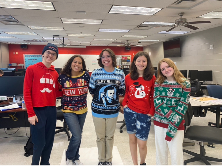 To get into the holiday spirit, members of the newspaper staff got dressed in their favorite holiday sweaters for “Twas the night before Tuesday.”