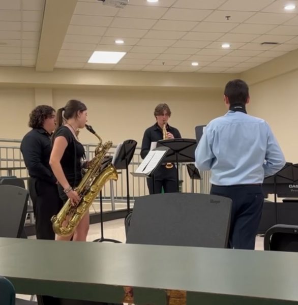 A saxophone quartet plays a piece for straight superiors.