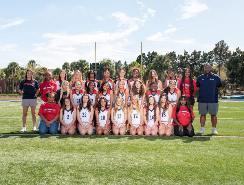 The inaugural girls flag football team takes their team photos.